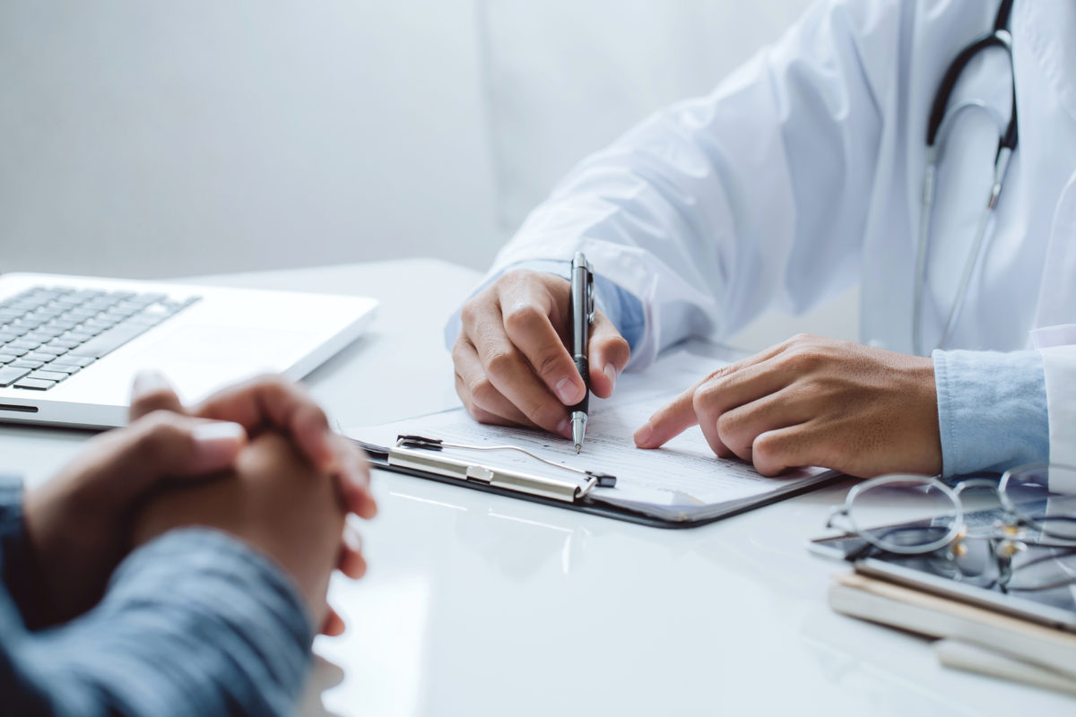 Prise de vue de mains de docteur et de son patient